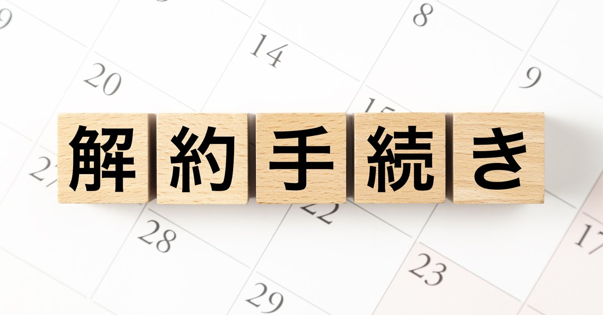 「解約手続き」と書かれた木のブロックとカレンダー